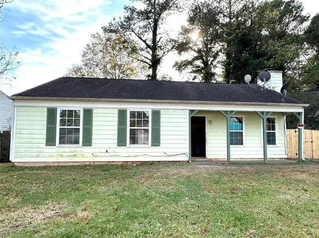 a front view of a house with a garden