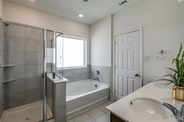a bathroom with a tub and sink