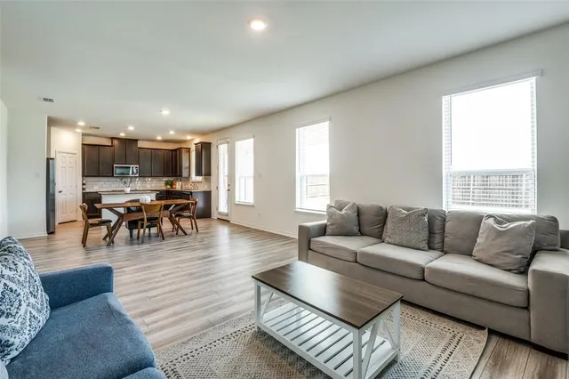 a living room with furniture and kitchen view