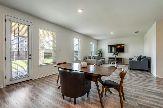 a dining room with furniture and wooden floor