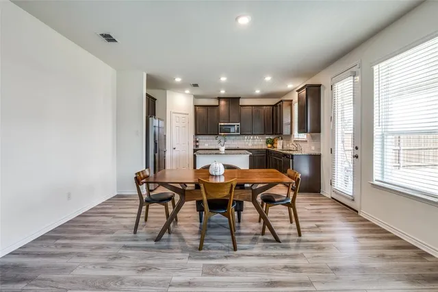 a view of a dining room with furniture and wooden floor