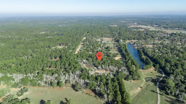 an aerial view of a house with a lake view
