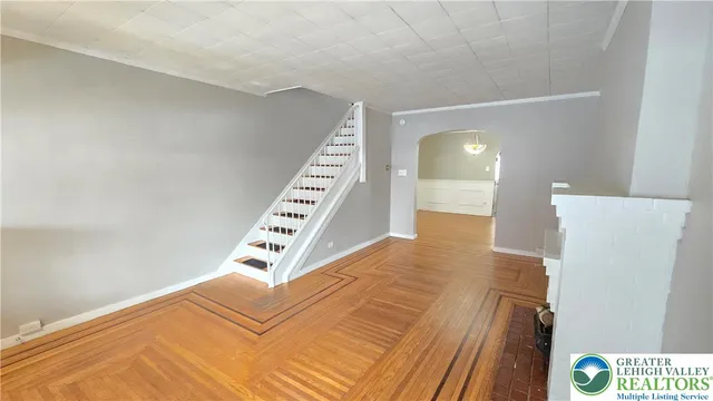 a view of an empty room with wooden floor