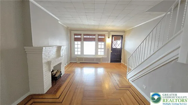 a view of entryway with wooden floor and stairs