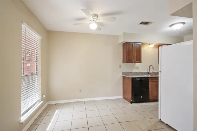a view of an empty room with window and cabinet