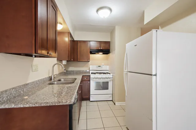 a kitchen with a sink a refrigerator and a stove