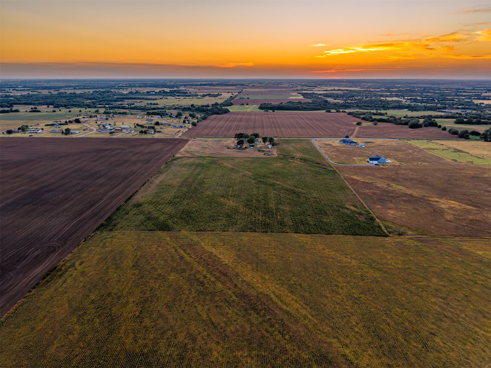 16 North Gregory Road Yukon, OK 73099 - Photo 19 of 34 Expansive acreage featuring cultivated fields, scattered mature trees, and a distant residential cluster