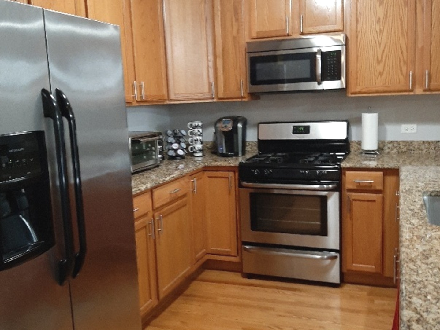 6436 Roosevelt Road, Unit 209 Oak Park, IL 60304 - Photo 3 of 25 a kitchen with stainless steel appliances granite countertop a stove microwave and refrigerator