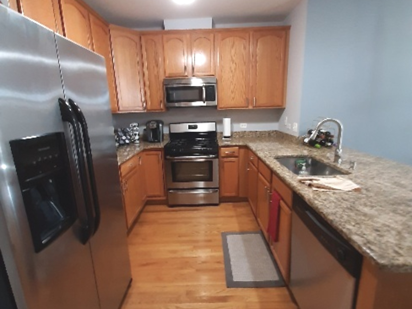 6436 Roosevelt Road, Unit 209 Oak Park, IL 60304 - Photo 4 of 25 a kitchen with stainless steel appliances granite countertop a sink stove and refrigerator