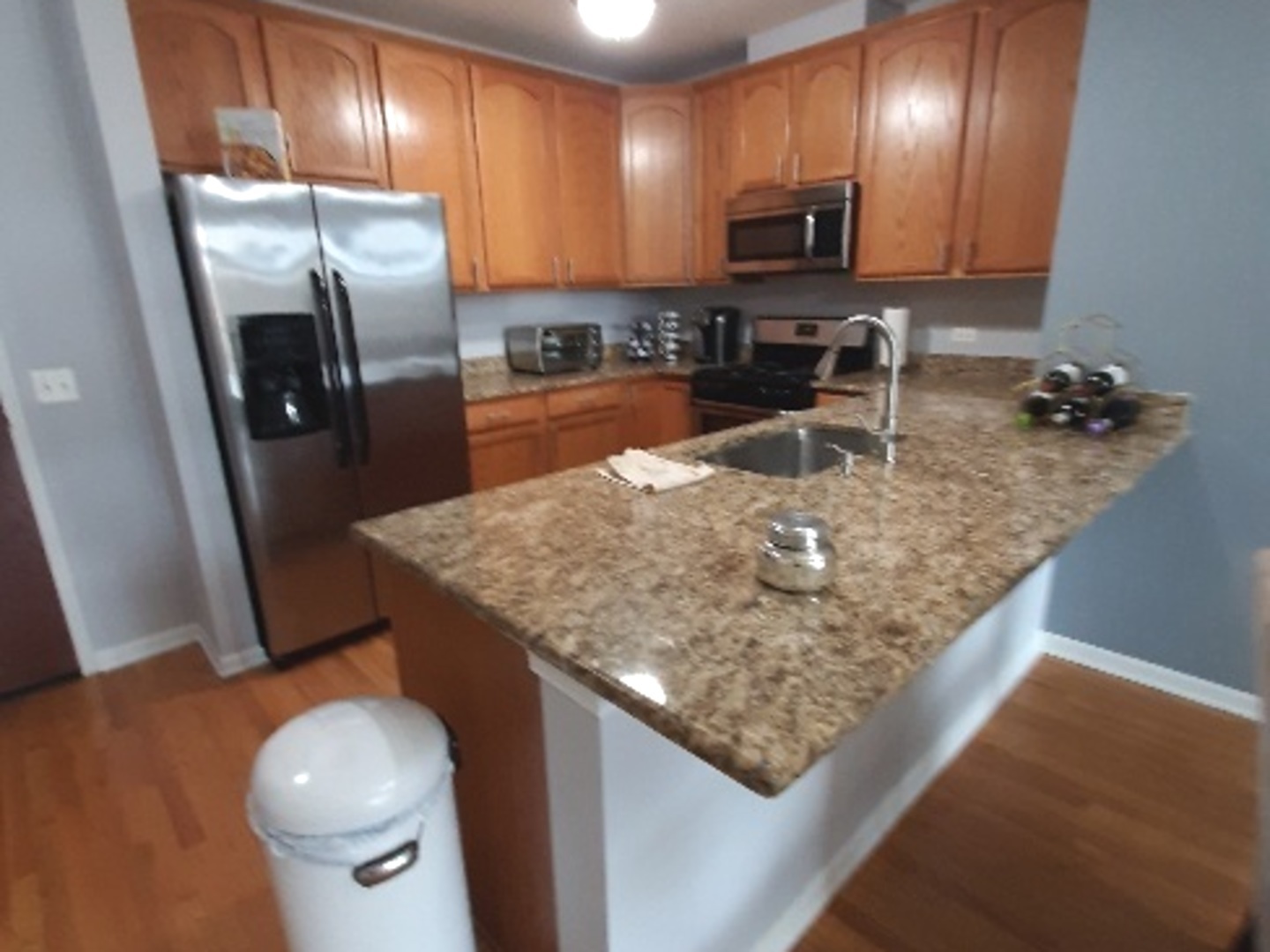 6436 Roosevelt Road, Unit 209 Oak Park, IL 60304 - Photo 5 of 25 a kitchen with stainless steel appliances granite countertop a sink a stove and a refrigerator