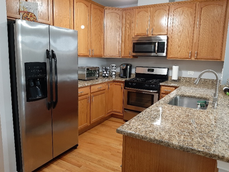 6436 Roosevelt Road, Unit 209 Oak Park, IL 60304 - Photo 8 of 25 a kitchen with stainless steel appliances granite countertop a refrigerator a stove a microwave a sink and cabinets