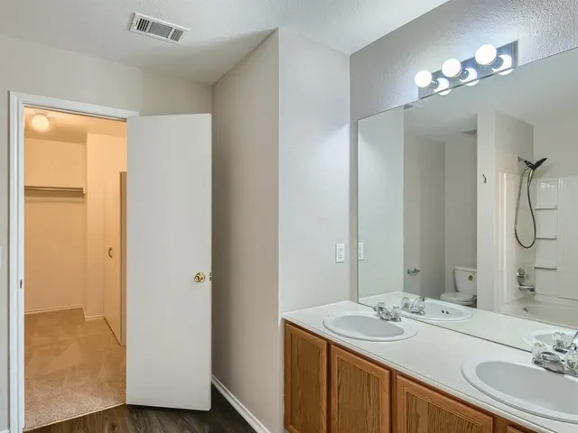 a bathroom with a sink double vanity and a mirror