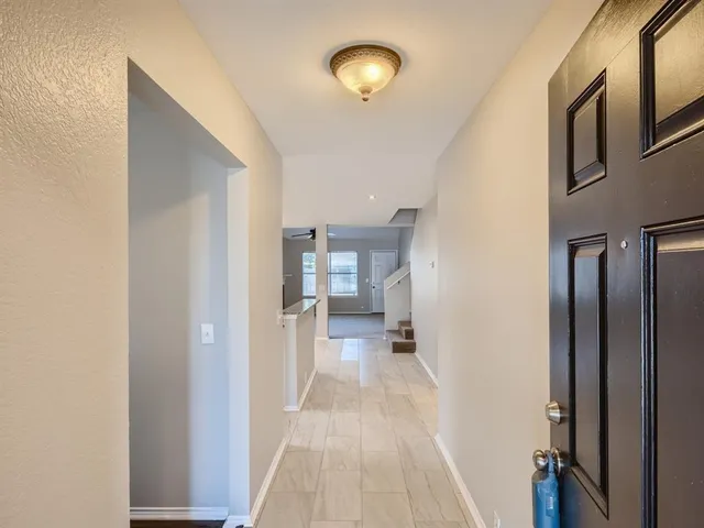 a view of a hallway with a wooden floor