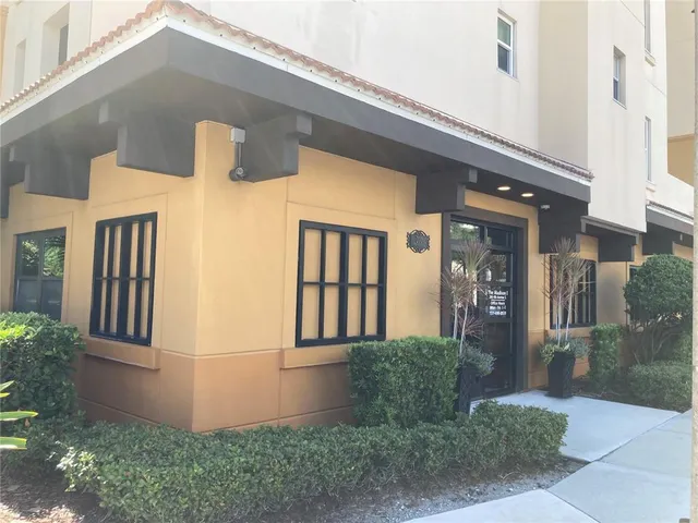 a front view of a house with plants