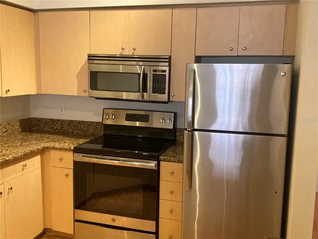 a kitchen with a refrigerator stove and microwave