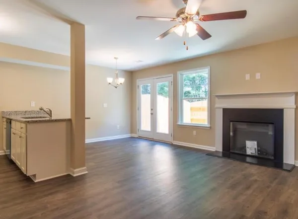 a view of a kitchen with wooden floor and a ceiling fan