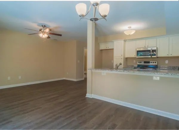 a kitchen with stainless steel appliances granite countertop a sink and a stove top oven