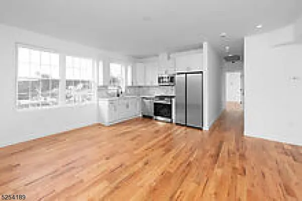 a view of a kitchen with a stove cabinets and wooden floor