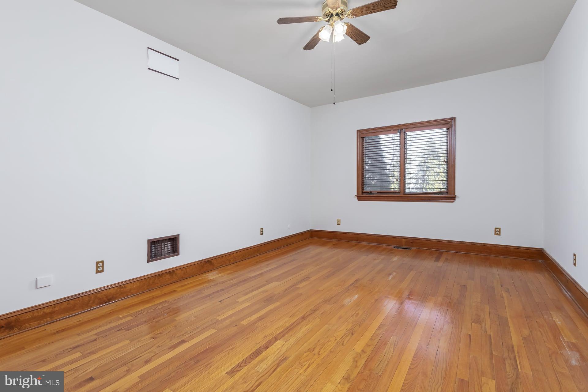 175 Queen Street West Deptford, NJ 08086 - Photo 14 of 23 a view of empty room with wooden floor and fan