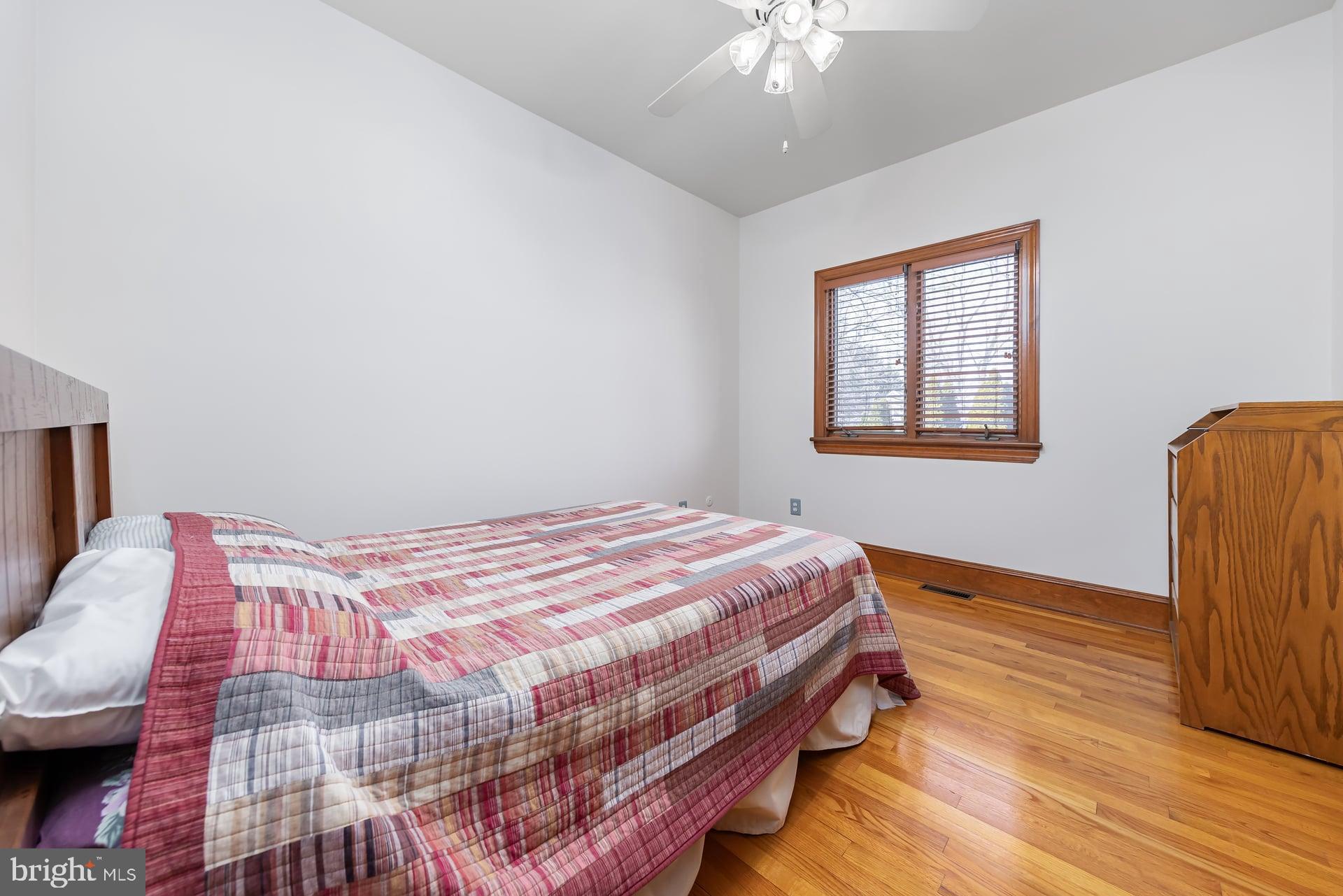175 Queen Street West Deptford, NJ 08086 - Photo 15 of 23 a bedroom with a bed and wooden floor