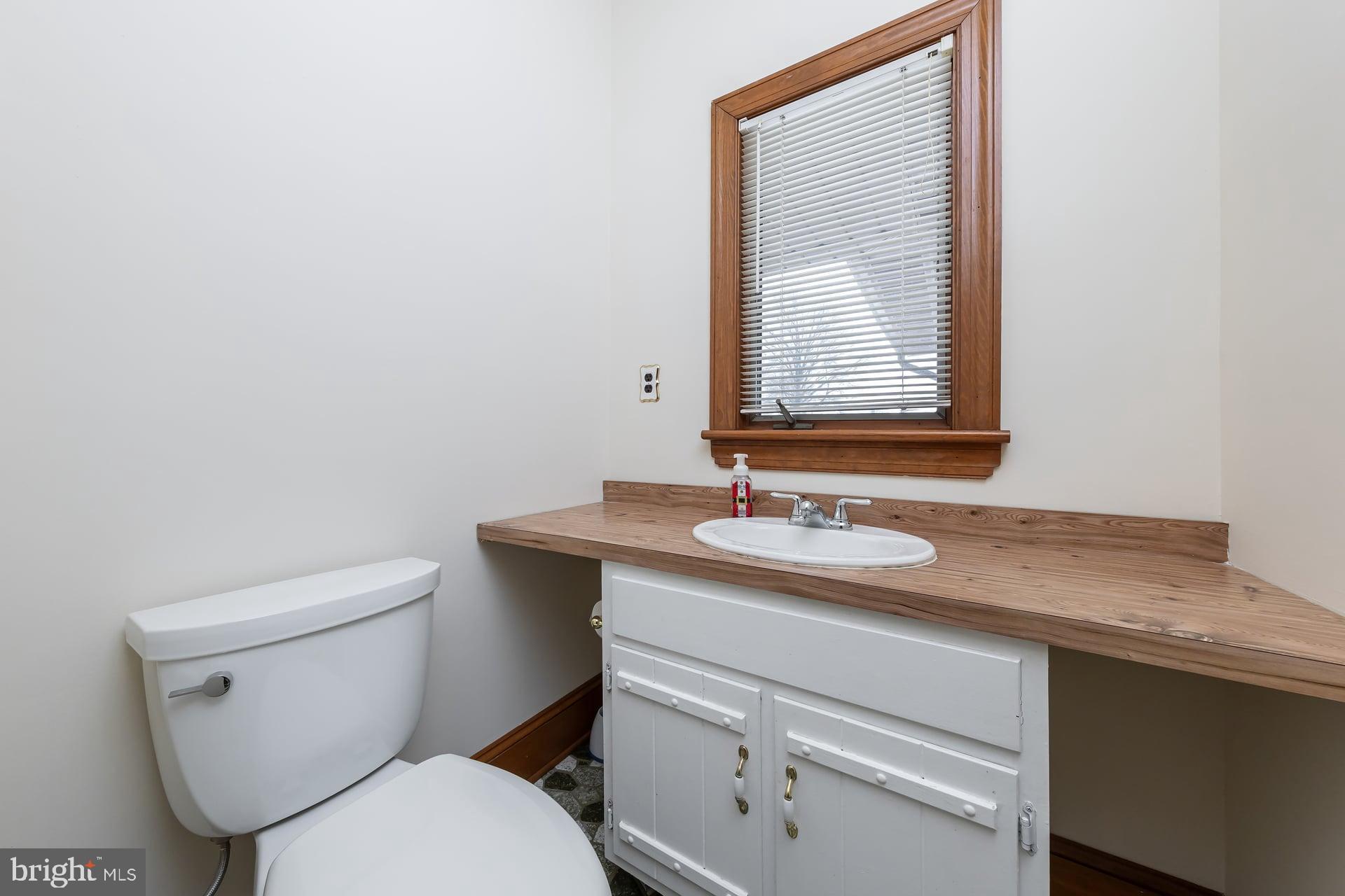 175 Queen Street West Deptford, NJ 08086 - Photo 9 of 23 a bathroom with a toilet sink and mirror