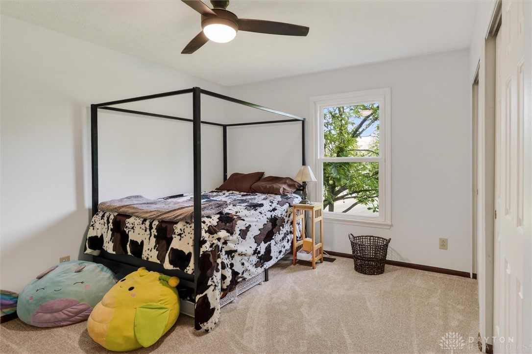 2165 Stewart Road Xenia, OH 45385 - Photo 31 of 59 This cozy bedroom features a large window offering verdant views, perfect for peaceful slumber.