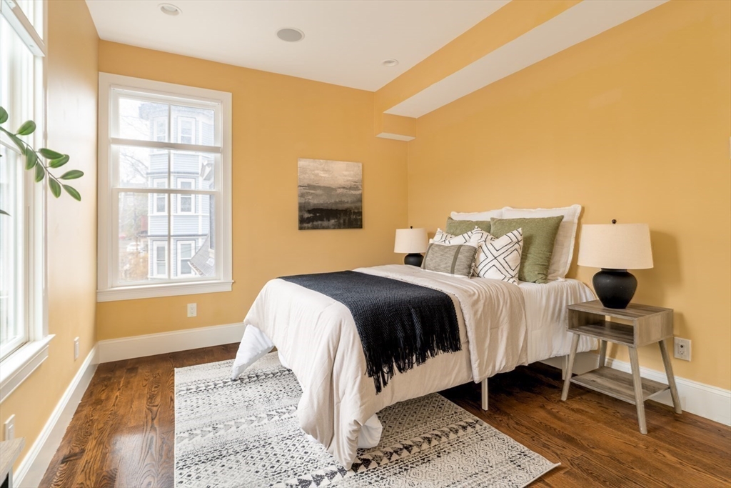 291 Lamartine Street, Unit 2 Boston, MA 02130 - Photo 11 of 18 a bedroom with a bed and wooden floor