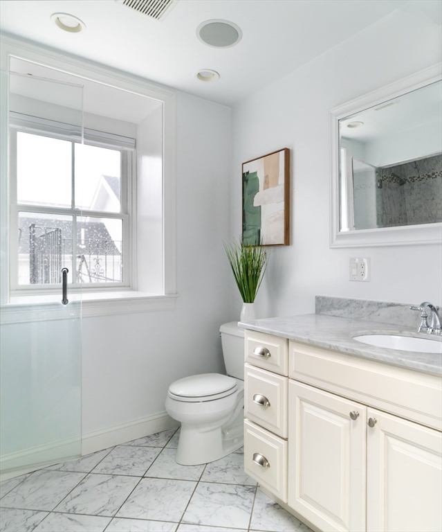 291 Lamartine Street, Unit 2 Boston, MA 02130 - Photo 13 of 18 a spacious bathroom with a granite countertop toilet a sink and a window