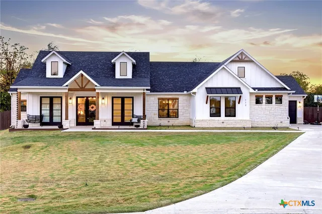 a front view of a house with a yard table and chairs
