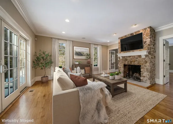 a living room with furniture fireplace and flat screen tv
