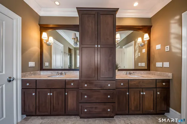 a bathroom with a double vanity sink and a mirror