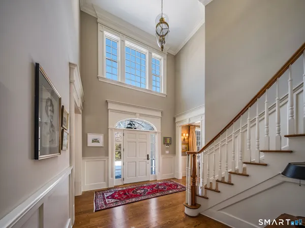 a view of an entryway with wooden floor