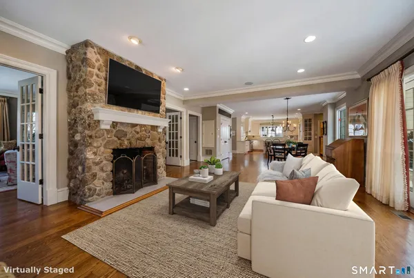 a living room with furniture a flat screen tv and a fireplace