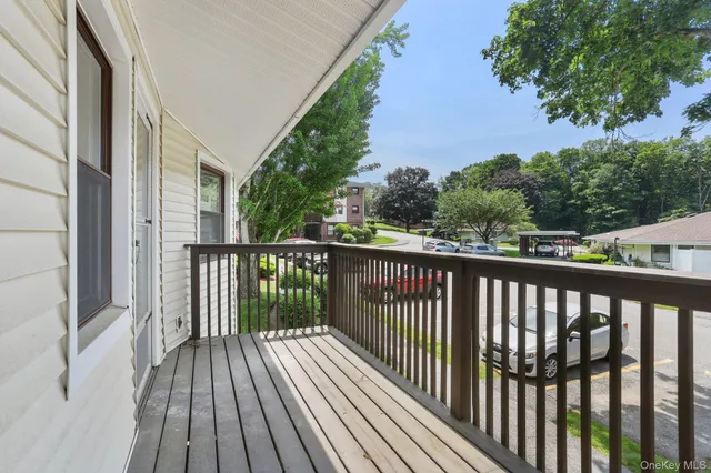 a balcony with wooden floor and fence