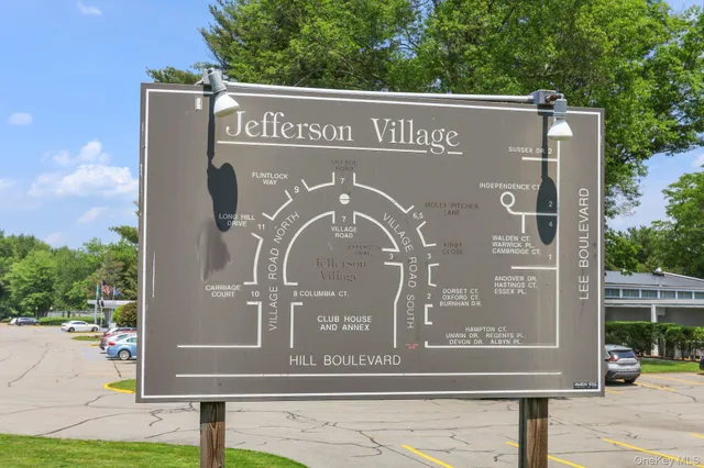 a front view of a building with trees