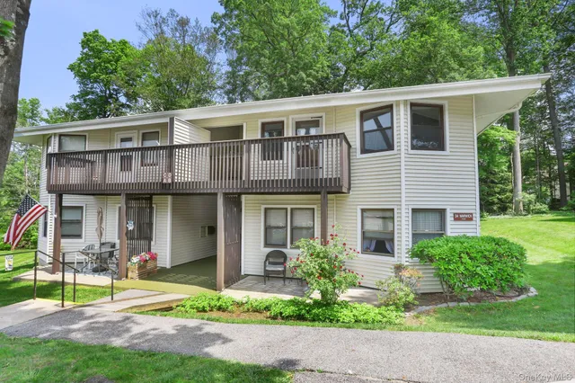 a front view of a house with garden and plants