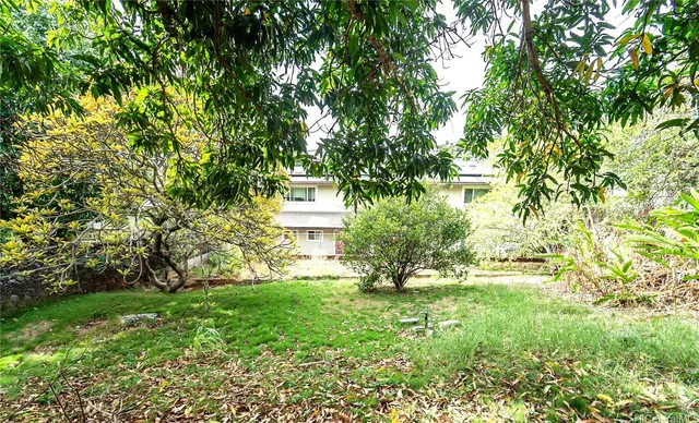 a view of house with backyard