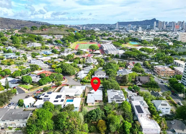 an aerial view of residential houses with outdoor space and street view