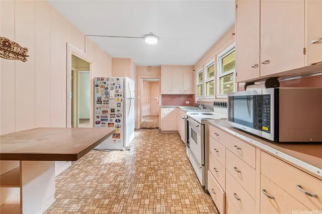 a kitchen with stainless steel appliances cabinets and a window