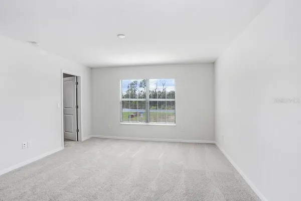 a view of an empty room and closet area