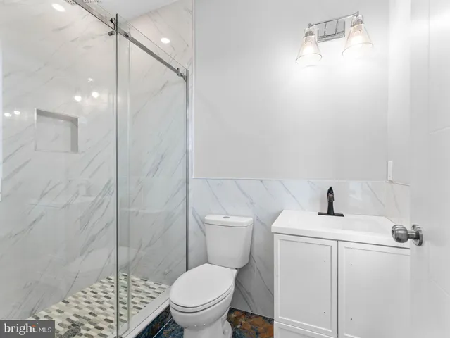 a bathroom with a toilet and a shower