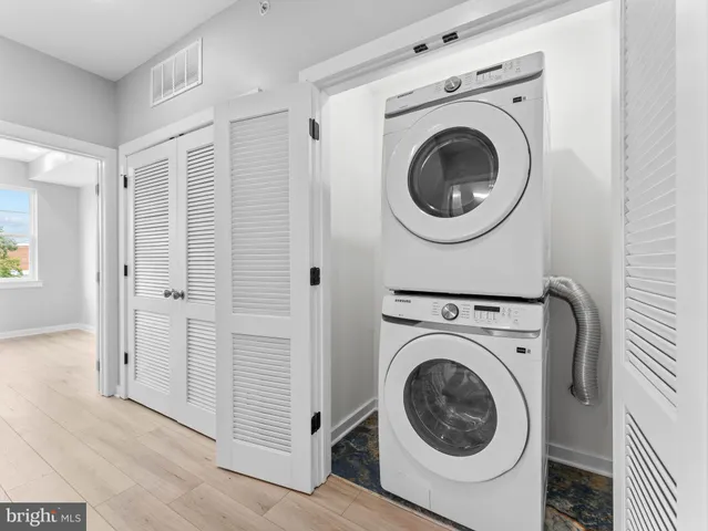 a view of a hallway with washer and dryer