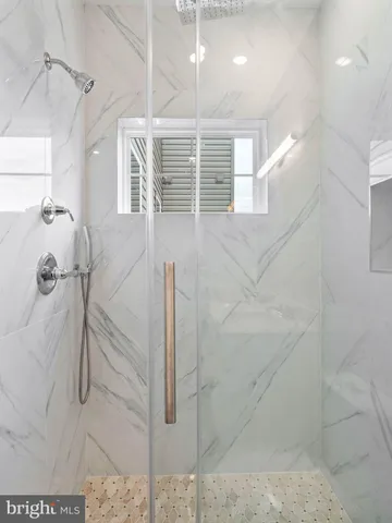a bathroom with a window and a shower