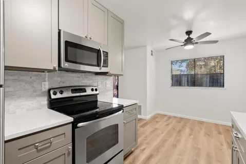 a kitchen with stainless steel appliances a stove microwave and cabinets