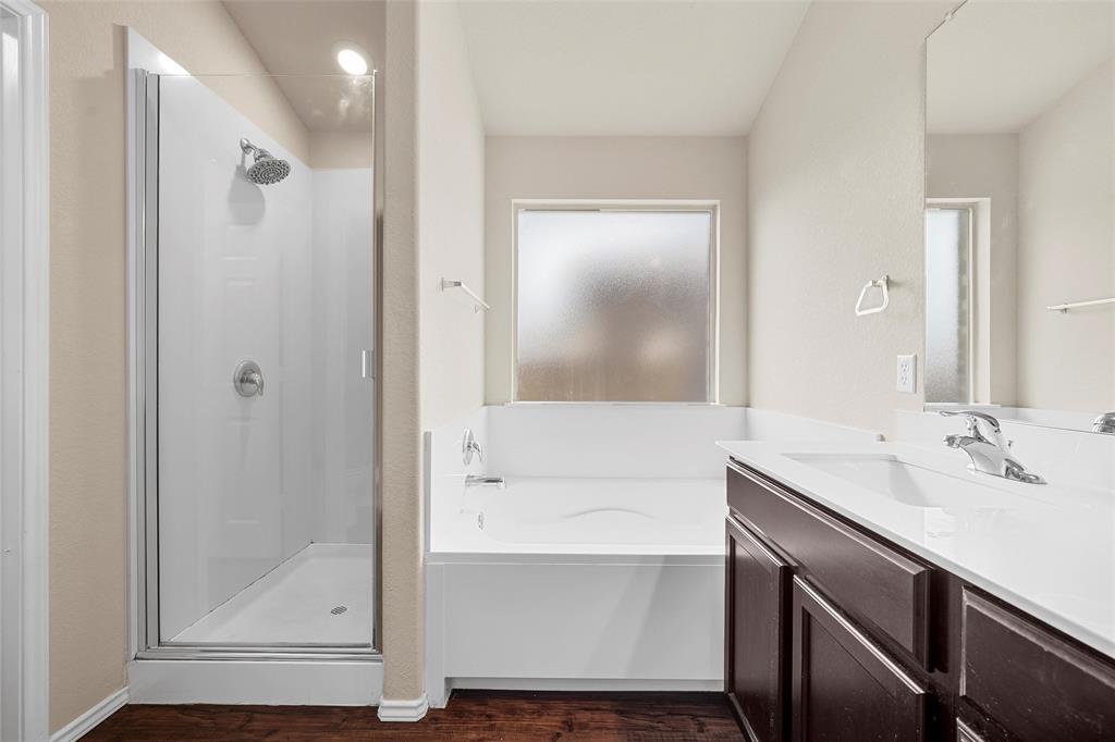 3217 Beutel Road Lorena, TX 76655 - Photo 20 of 40 Full bathroom with a shower stall, a garden tub, vanity, and wood finished floors