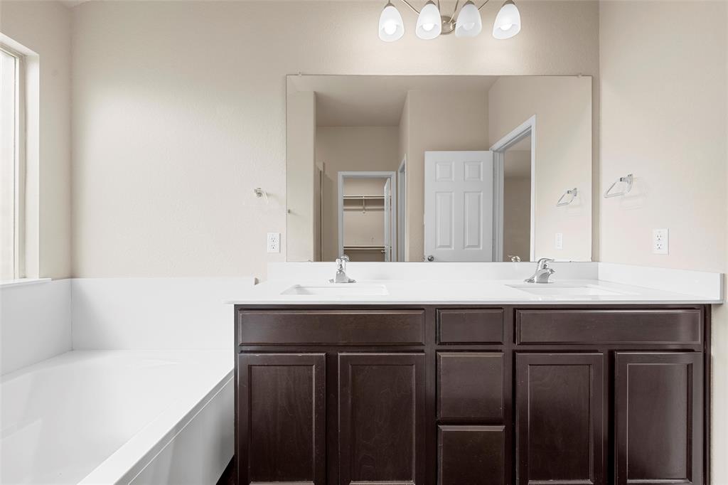 3217 Beutel Road Lorena, TX 76655 - Photo 21 of 40 Full bathroom featuring double vanity and a bath