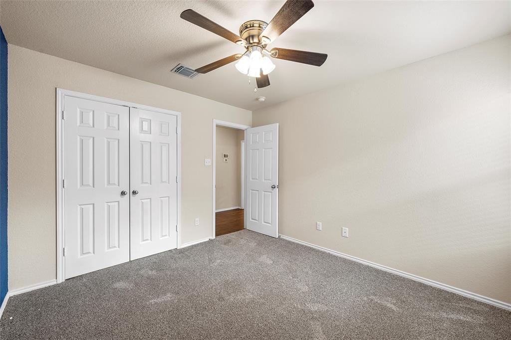 3217 Beutel Road Lorena, TX 76655 - Photo 25 of 40 Unfurnished bedroom with carpet flooring, a closet, and ceiling fan