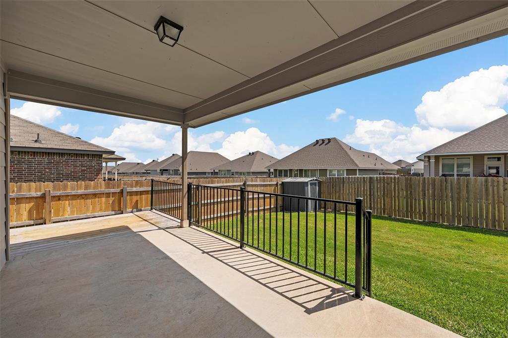 3217 Beutel Road Lorena, TX 76655 - Photo 28 of 40 Fenced backyard with a patio, a shed, and a residential view