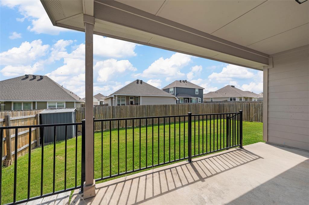 3217 Beutel Road Lorena, TX 76655 - Photo 35 of 40 Fenced backyard featuring a residential view, a storage unit, and a patio area