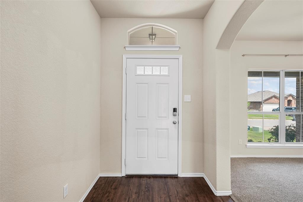3217 Beutel Road Lorena, TX 76655 - Photo 6 of 40 Foyer featuring arched walkways, healthy amount of natural light, and dark wood-style flooring